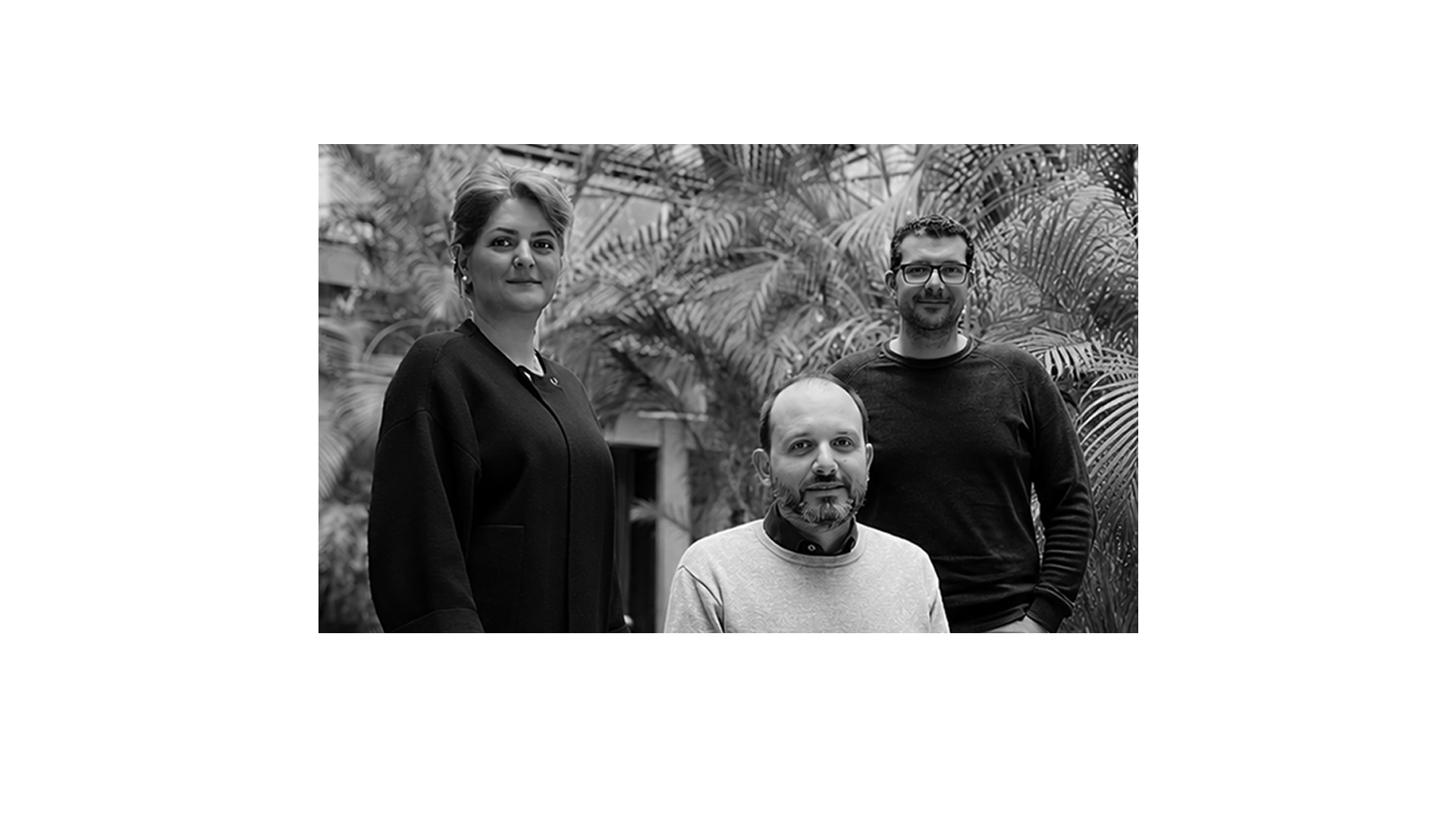 A black and white photo of three members of the Arxax team