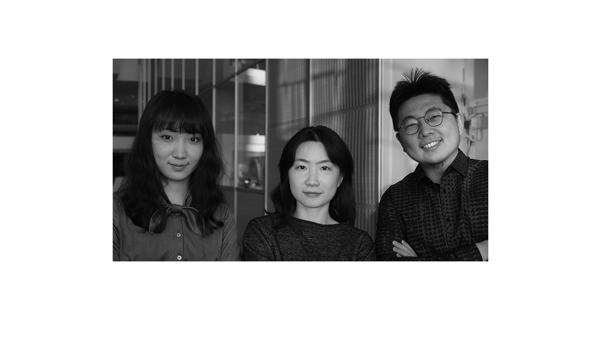 Black and white photo of three smiling CellaNexa team members