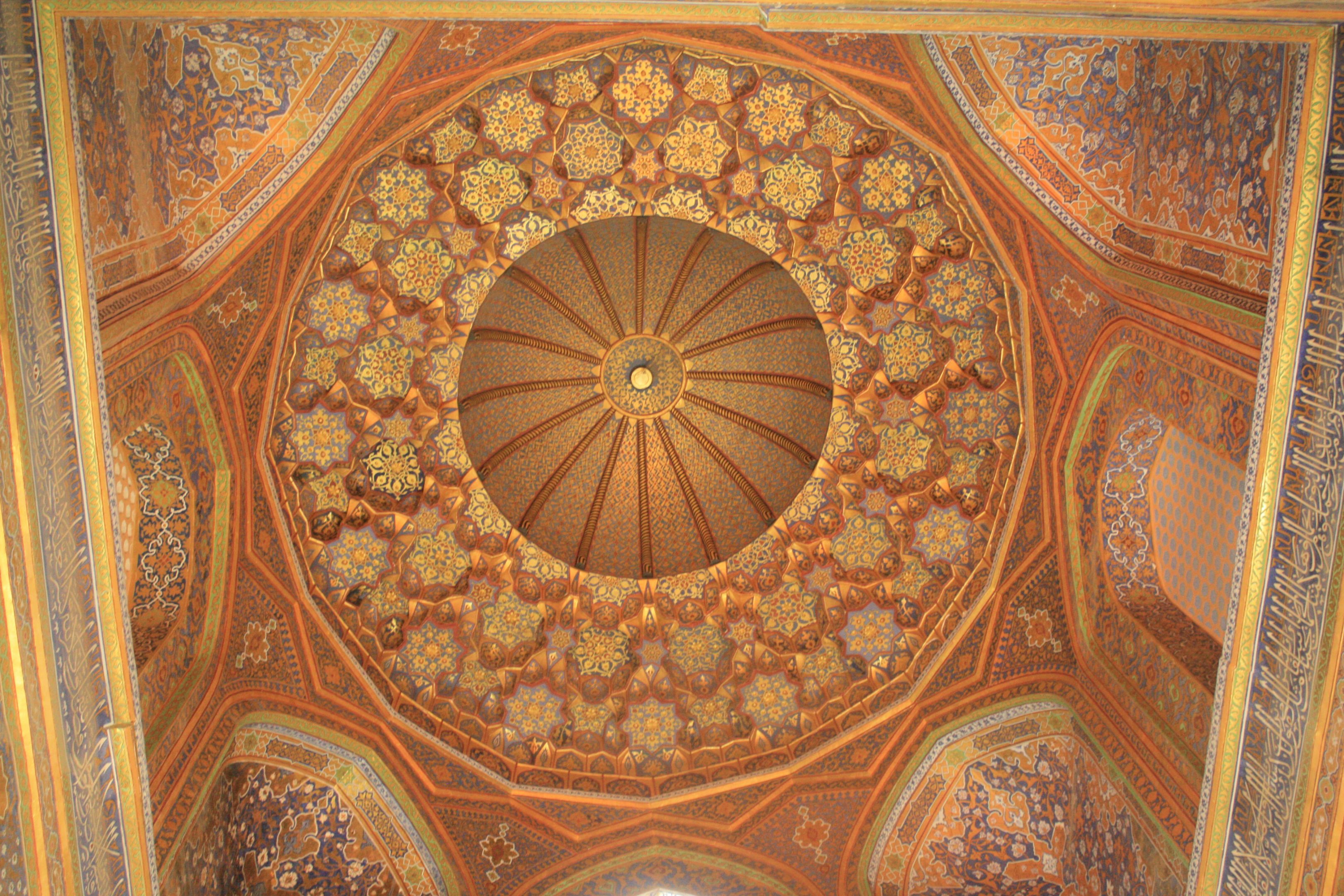 HIghly painted, golden interior of dome from a madrasa in Samarkand