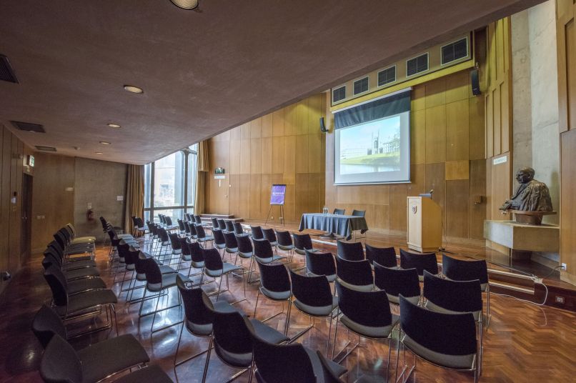 a lecture theatre with a table and screen