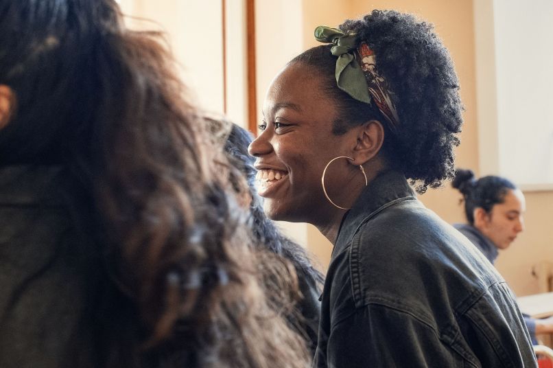 Student smiling and facing the side. 