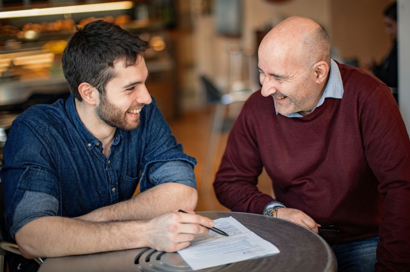 male graduate student with supervisor laughing