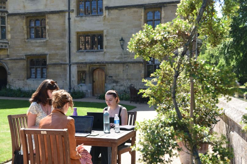 Three students working in the sun