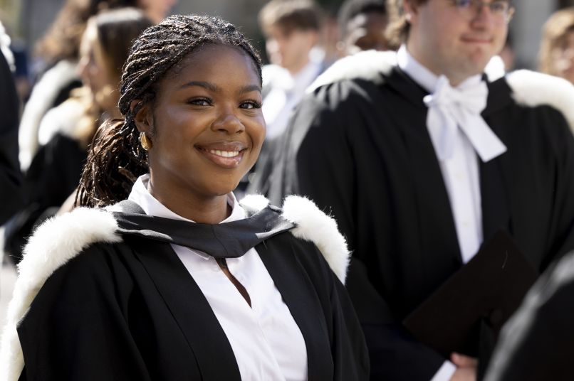 Student smiling in graduation dress