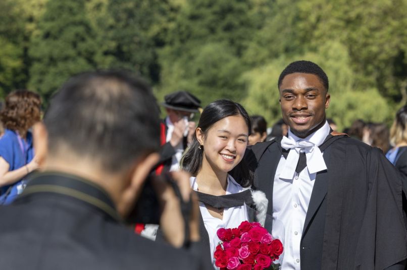 two graduating students being photographed