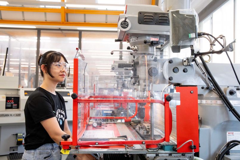 A student working on a machine