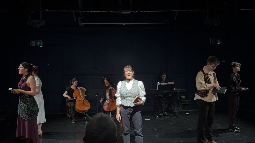 Cast and musicians on stage