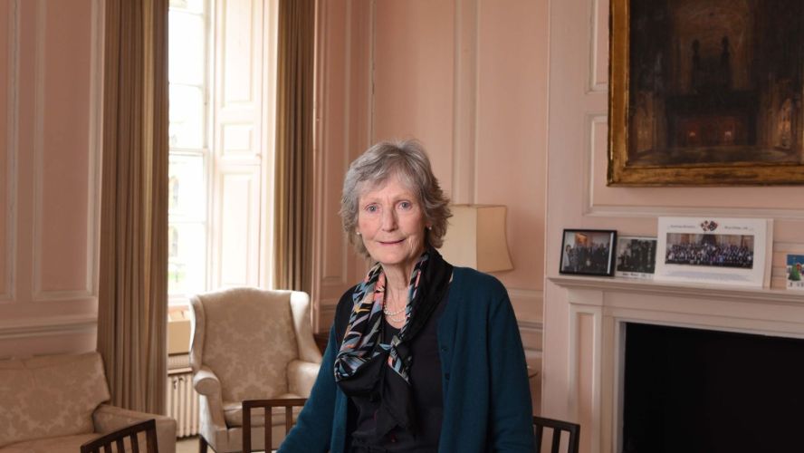 A smiling woman in an elegant room  