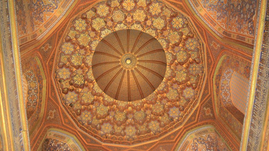 HIghly painted, golden interior of dome from a madrasa in Samarkand