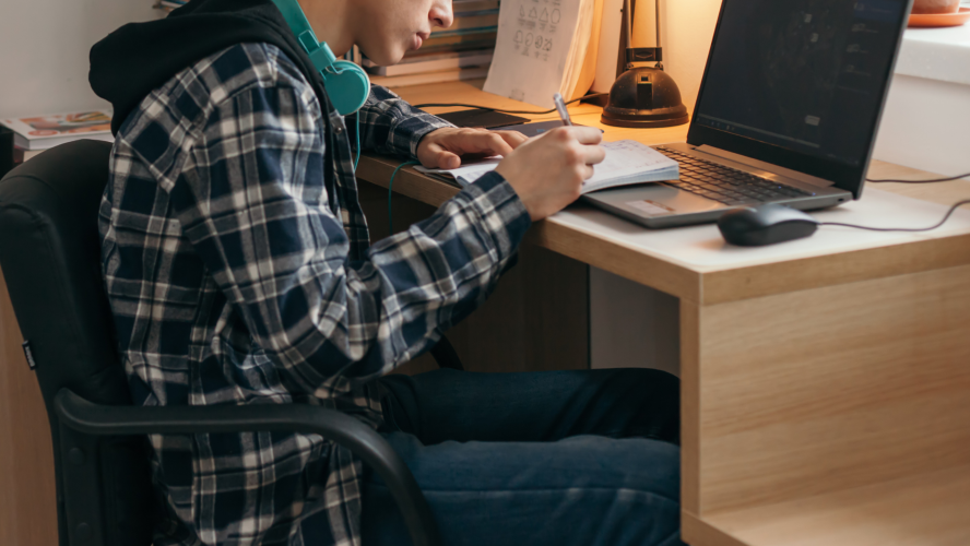 Young man writing on a notebook