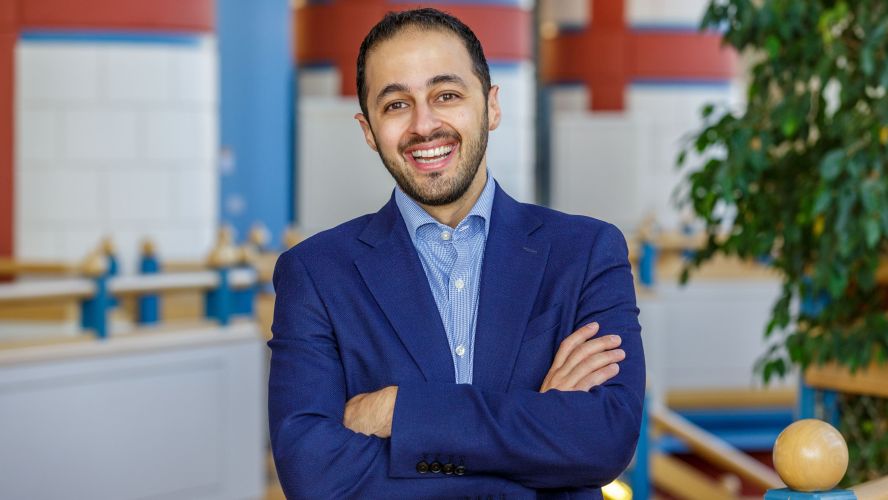kamiar mohaddes at jbs smiling with his arms crossed