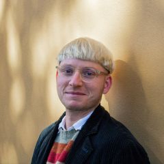a man wearing glasses with blond hair