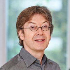 Matthew Gandy, a picture of a smiling man in glasses, wearing a grey shirt