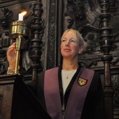 Chapel Manager lighting a candle