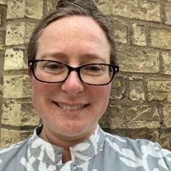 Janet Davis, smiling woman wearing glasses