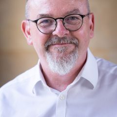 smiling bald man in a white shirt