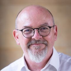 smiling bald man in a white shirt