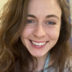 smiling white female with long wavy brown hair 