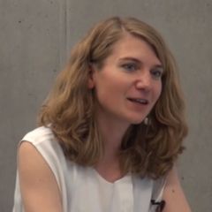 Angela Breitenbach, a smiling woman with long blond hair wearing a white top