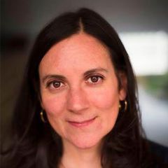 Caroline Goodson, a smiling woman with long dark brown hair and brown eyes