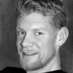 Henning Gross Ruse Khan, a black and white photo of a man smiling man with short fair hair and beard.