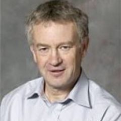 Ross Harrison, a smiling man with grey hair wearing a white shirt.
