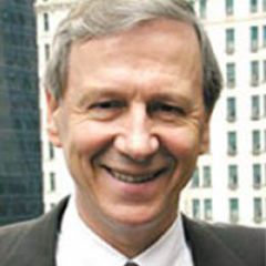 Anthony Giddens, a smiling man with grey hair wearing a suit