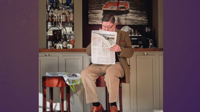 Jim Trevithick, sitting at a bar and reading a newspaper