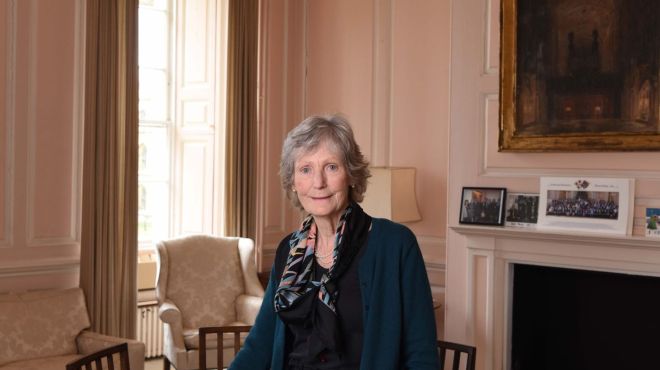 A smiling woman in an elegant room  