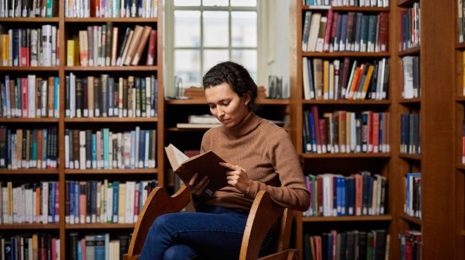 A woman reading in a library
