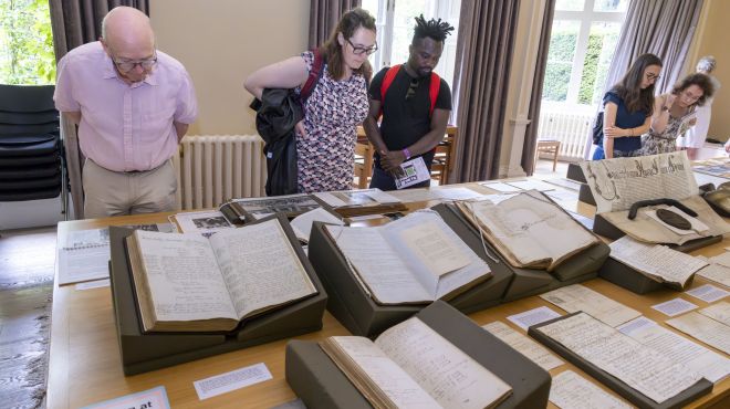 alumni-looking-at-archive-display-in-audit-room