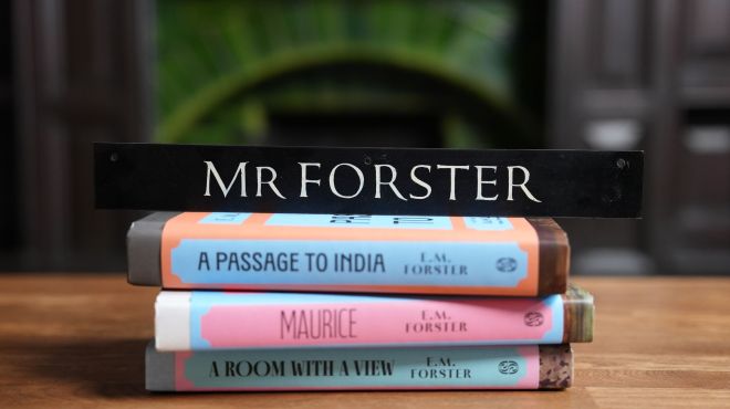 EM Forster's name plate sits perched on a stack of his novels