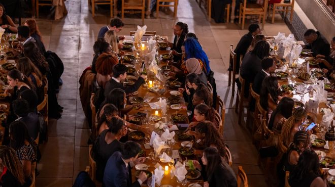 students in a formal dining hall meal