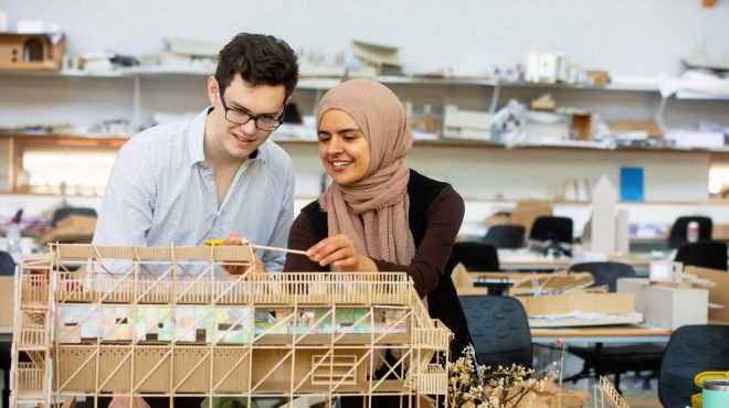 architecture students assemble a model building