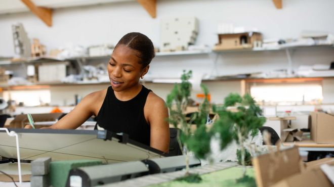 a female student works in an architecture and design studio