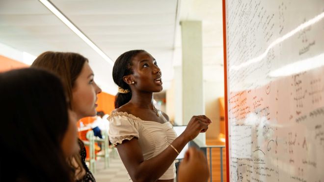 students around a white board