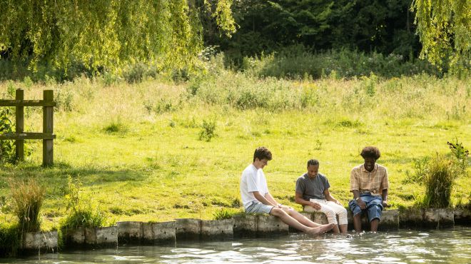 Students sat by the river