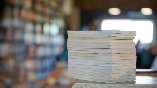 a stack of books on top of a bookcase