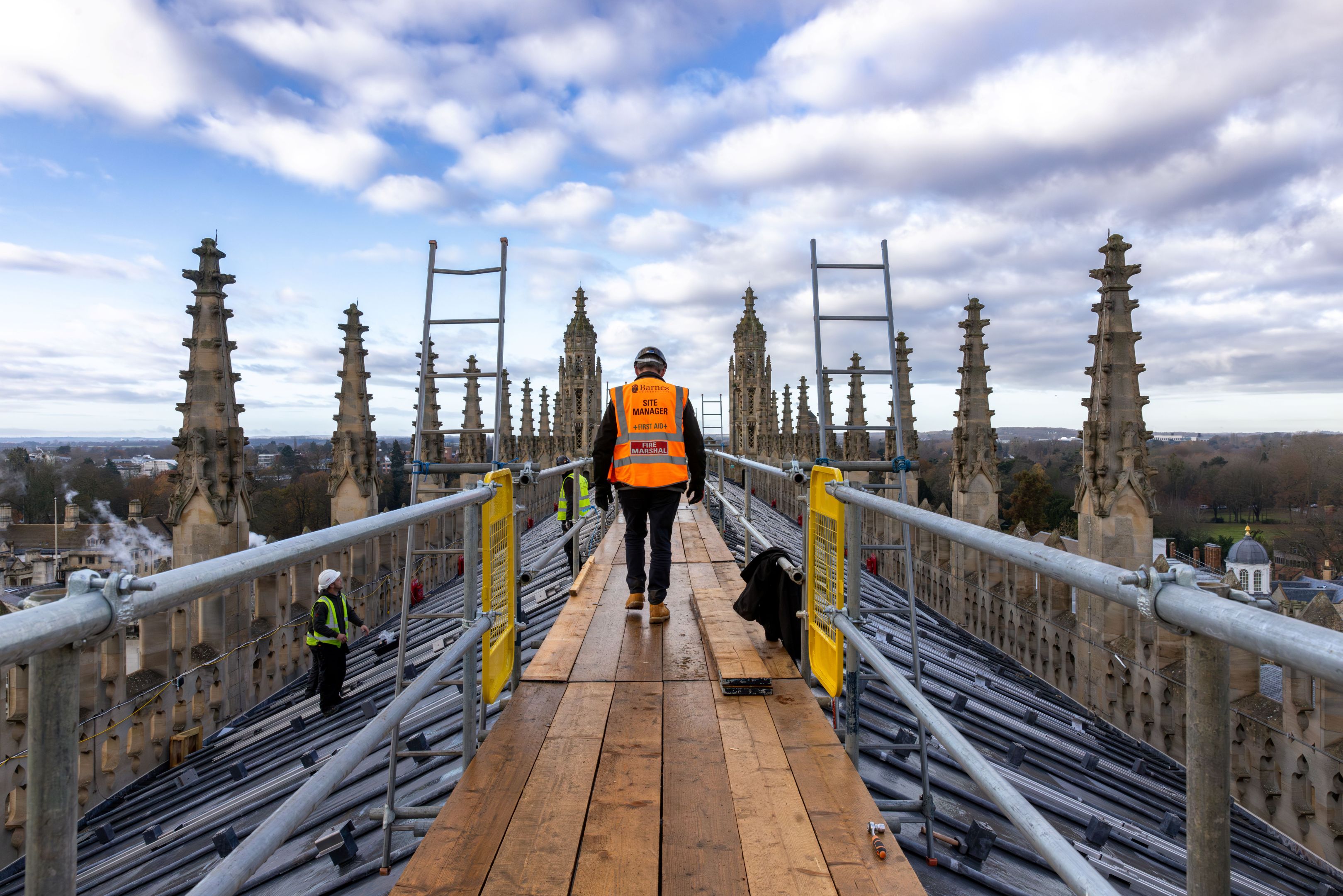 A construction worker on King's College Chapel roof with safety equipment