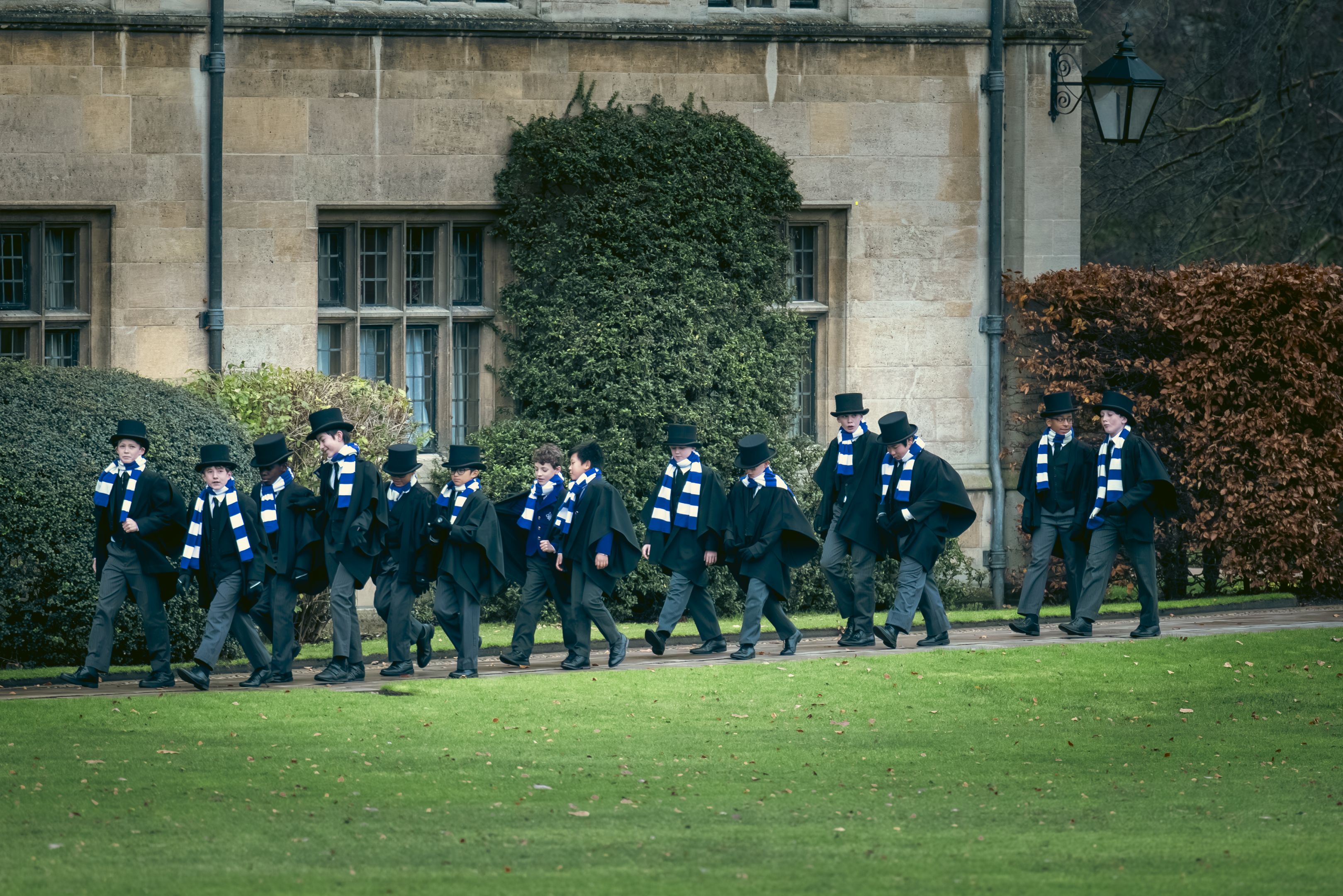 Photo of choristers in top hats and scarves