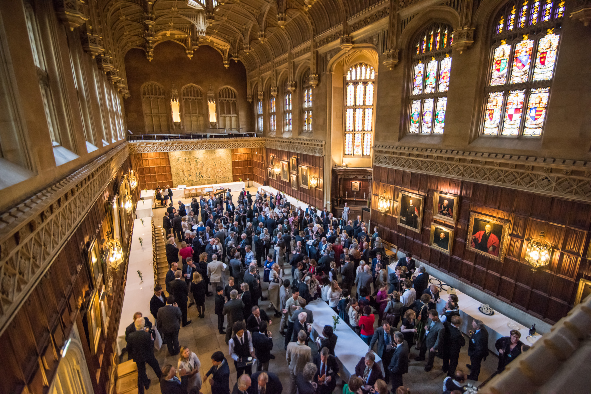 A group of people in a formal dining hall