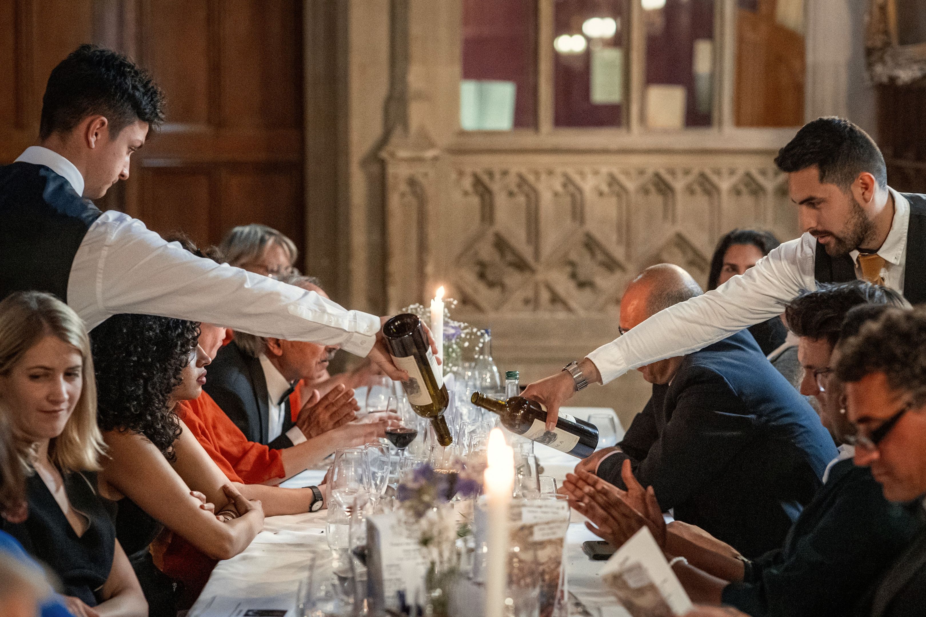 Waiters serving wine 