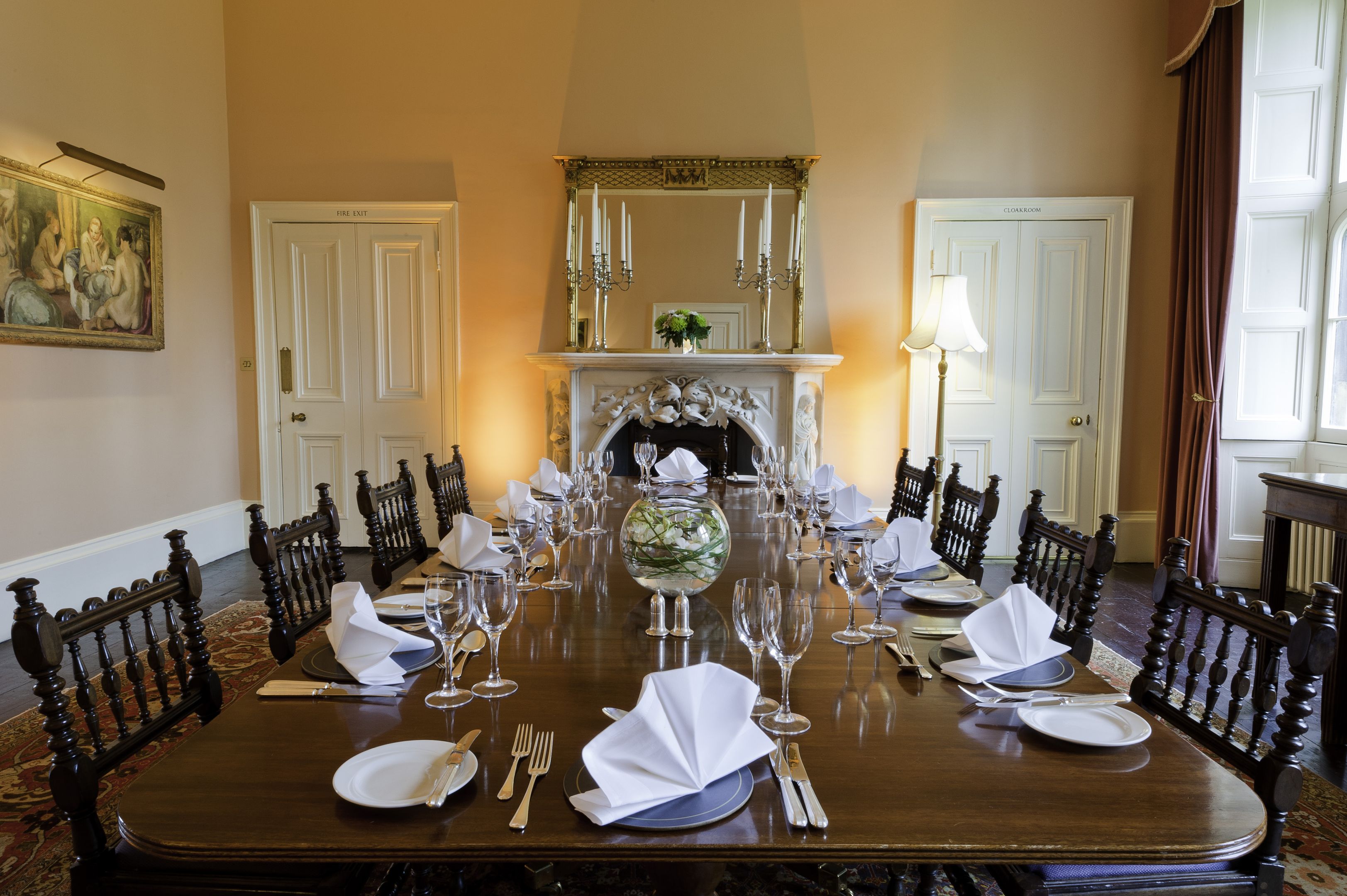 Dining room with wooden table and formal place settings