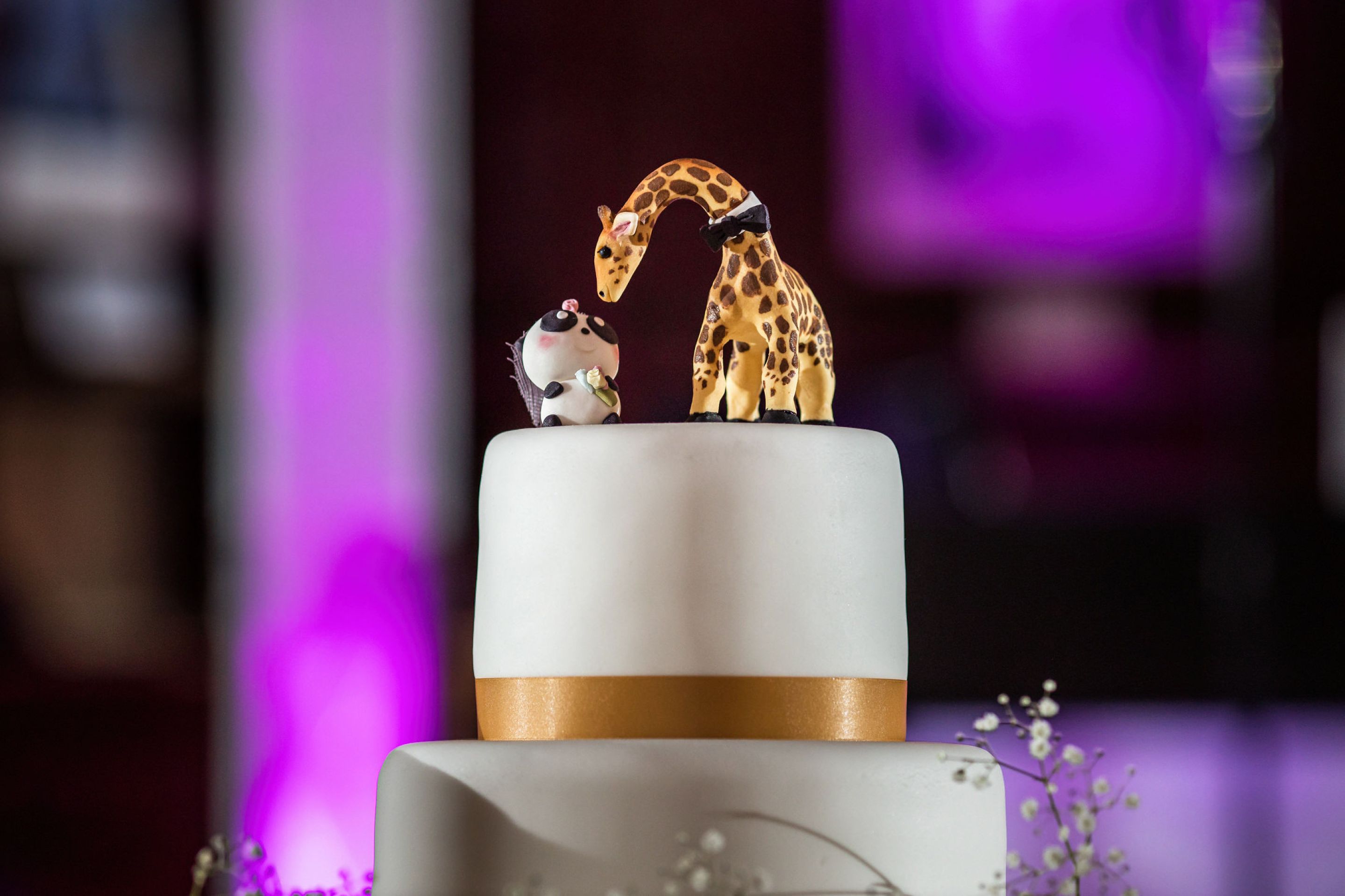 a wedding cake with animal decorations on top