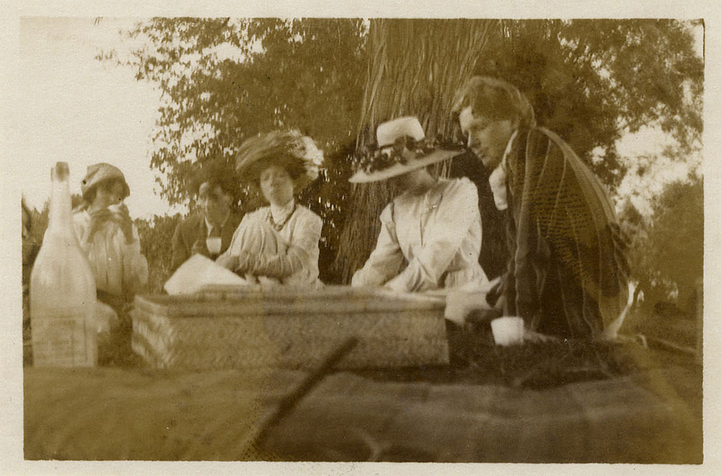 old photo of four people sat in Grantchester