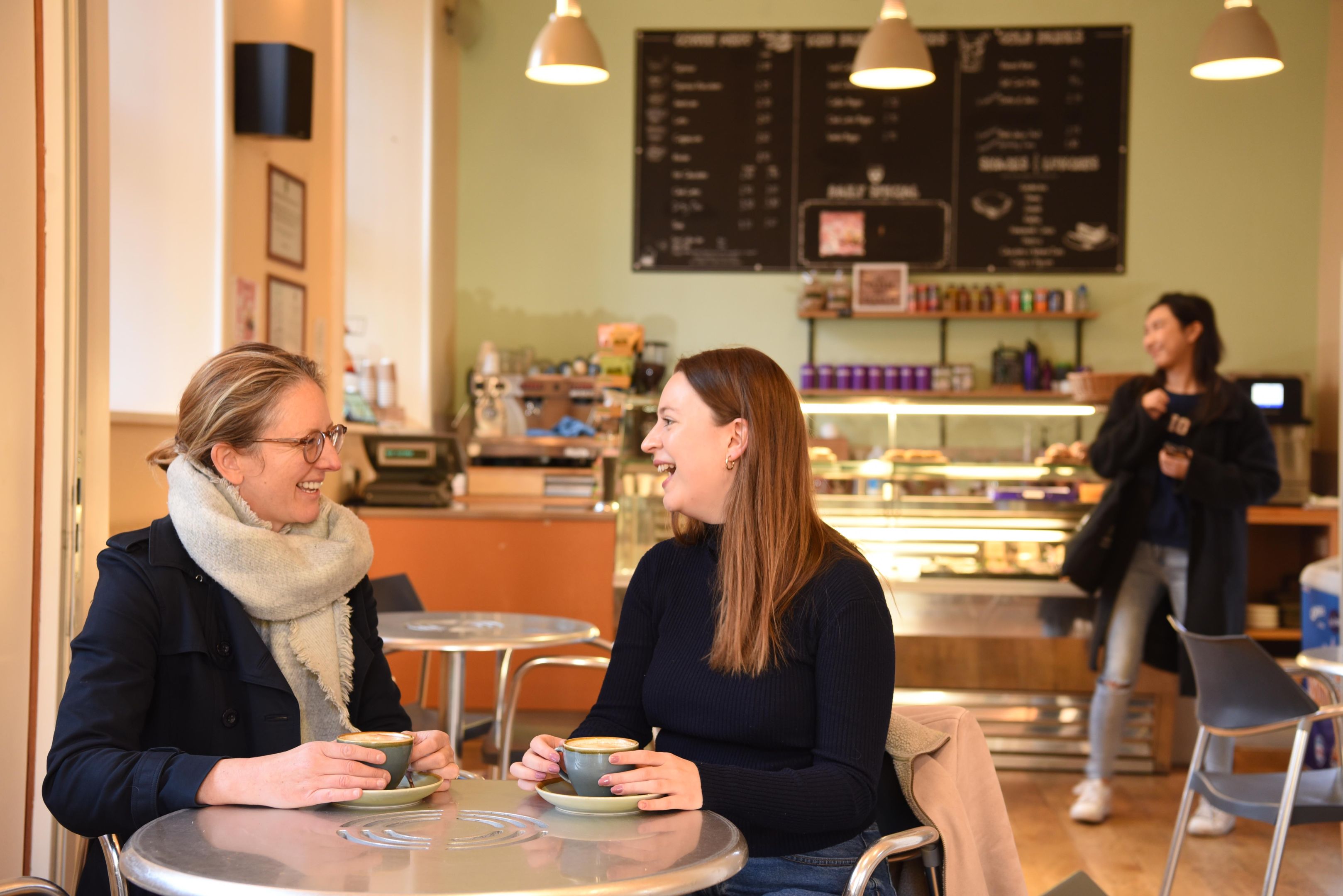 Two women talking in the College coffee shop