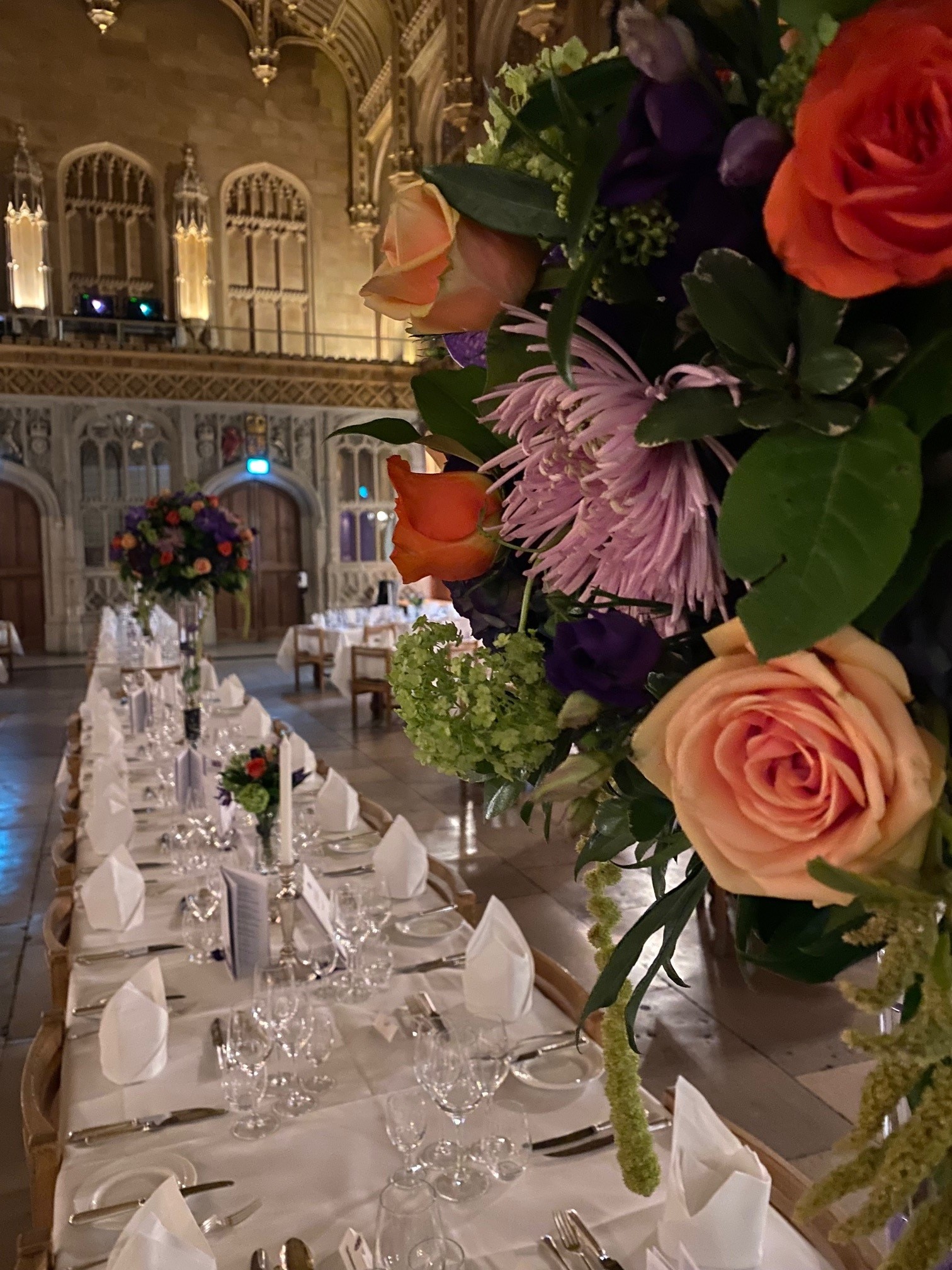 The Hall set up for formal dining with a large flower arrangement