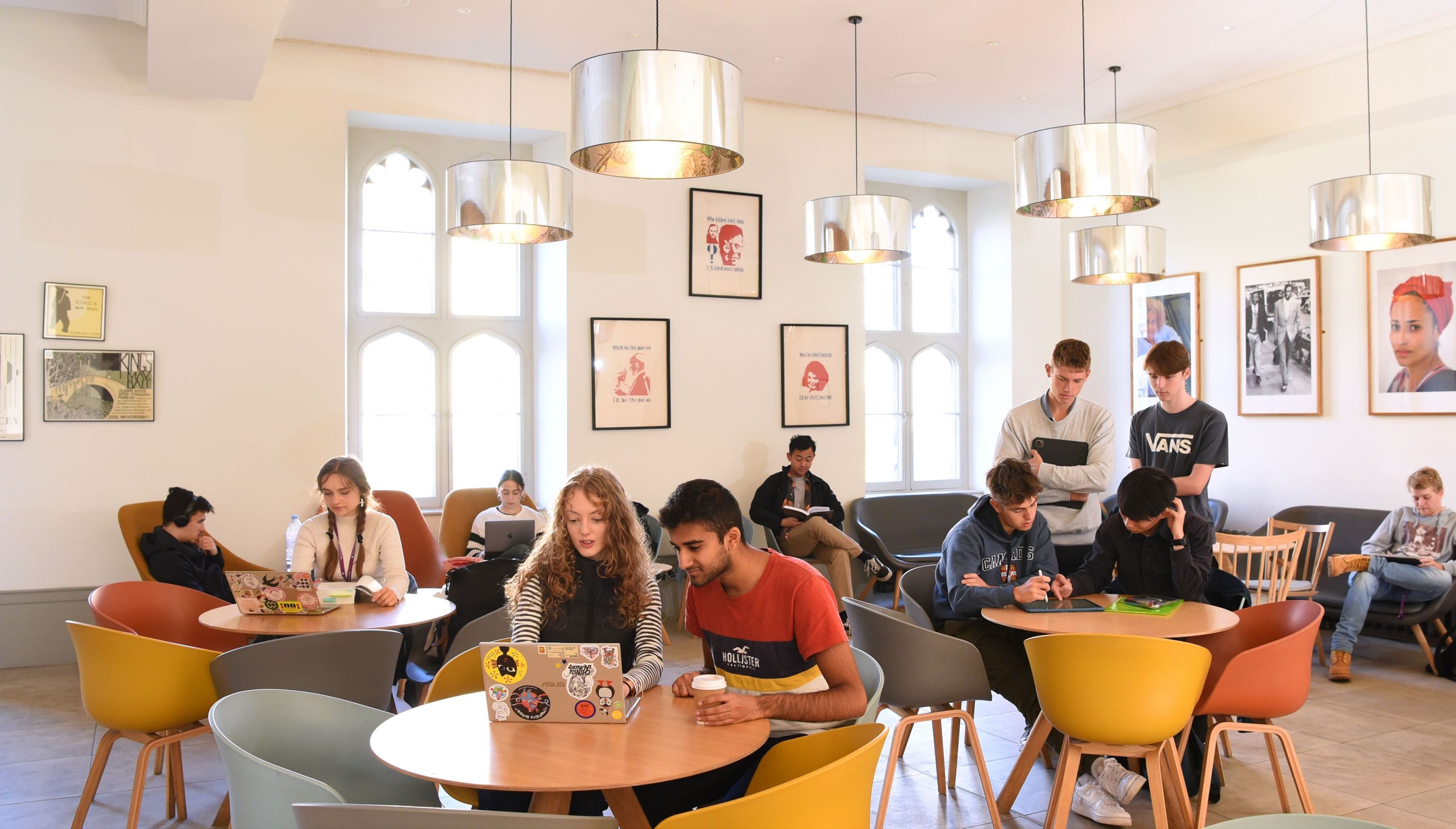 students sitting at tables in a common area