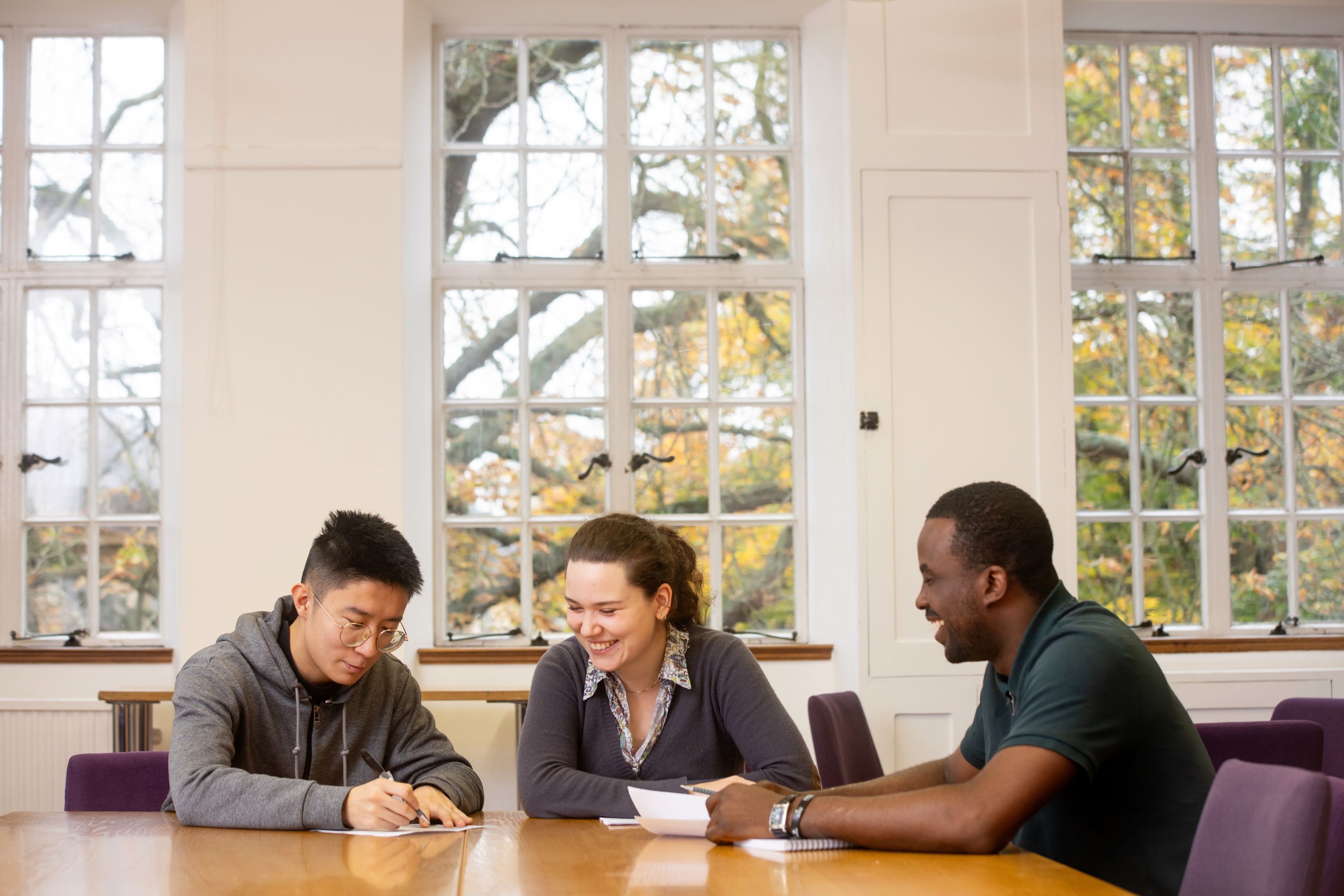 Three students working at a table