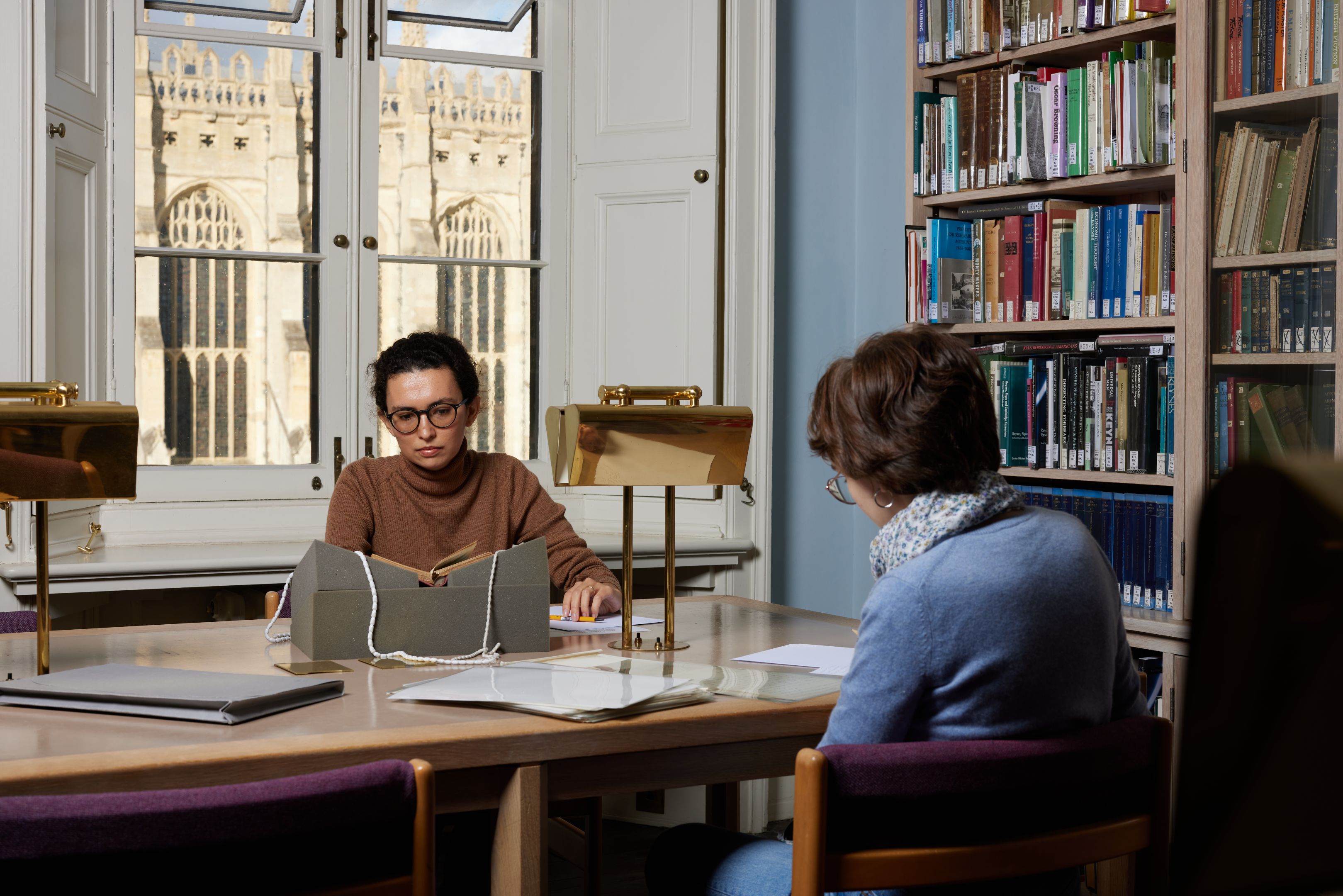 Two female students working in the reading room